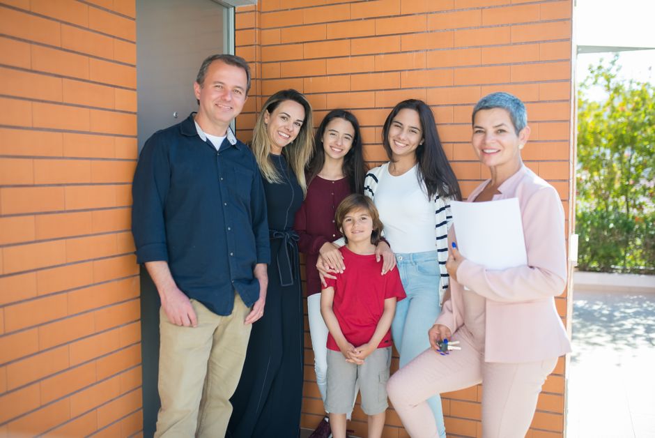 Military vs Army vs Navy: Key Differences, Benefits, and Careers 3 A family standing in front of their newly purchased home using a VA loan